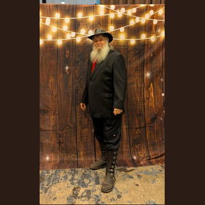 Author Donald Maxwell III dressed in black with a wide-brimmed hat